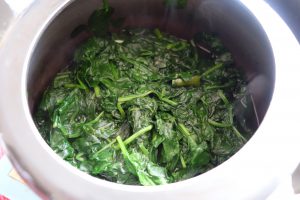 Boiled/ blanched spinach leaves in a cooker