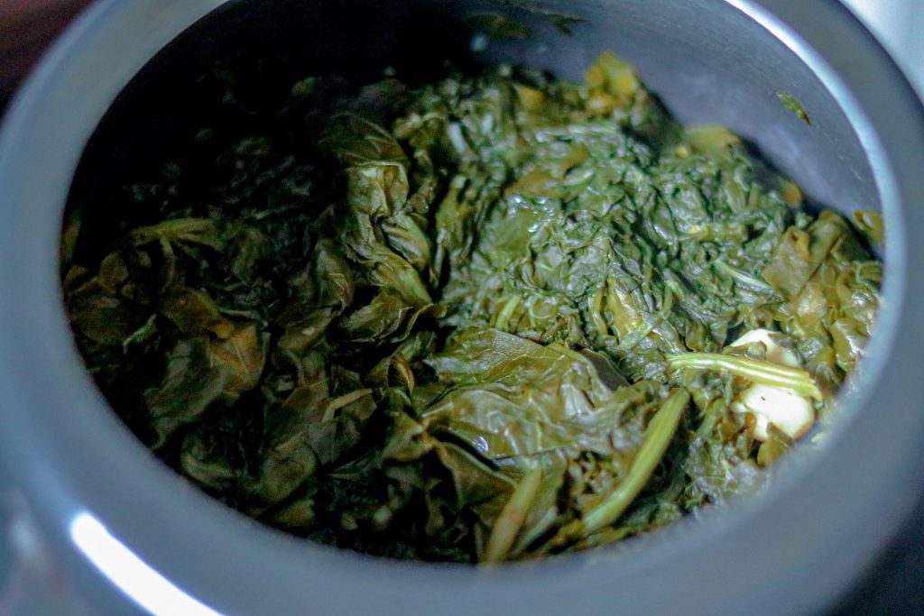 Cooked saag leaves in cooker