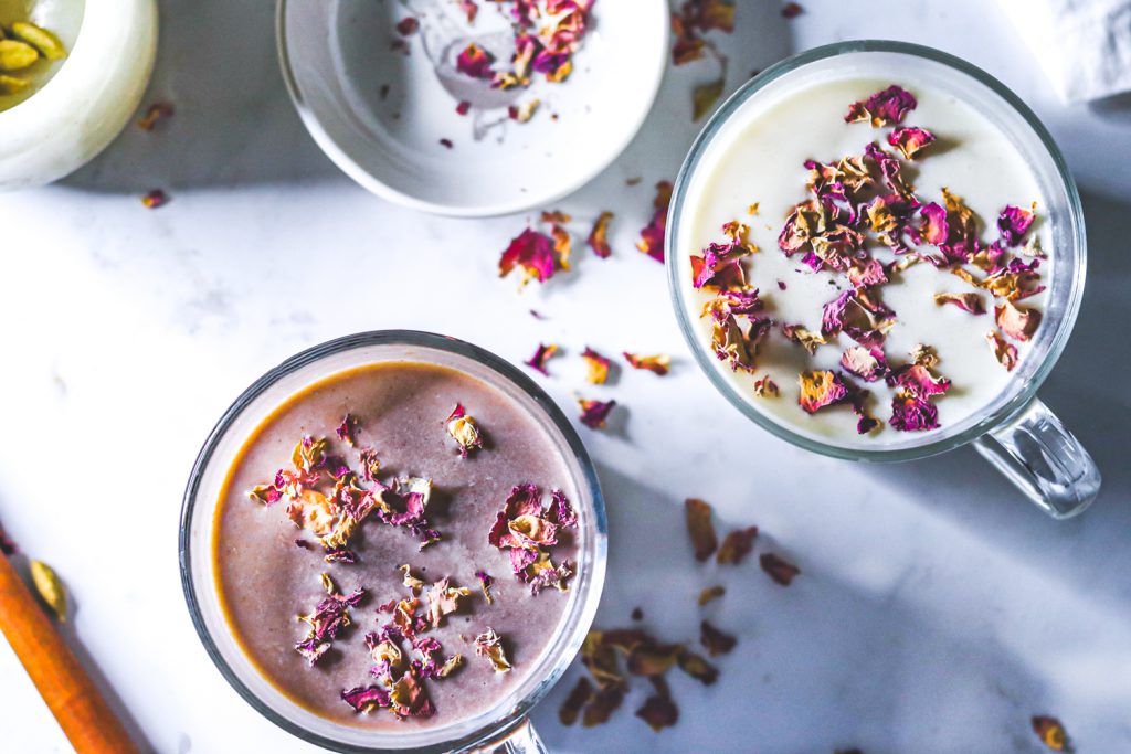 hot chocolates in mugs garnished with rose petals