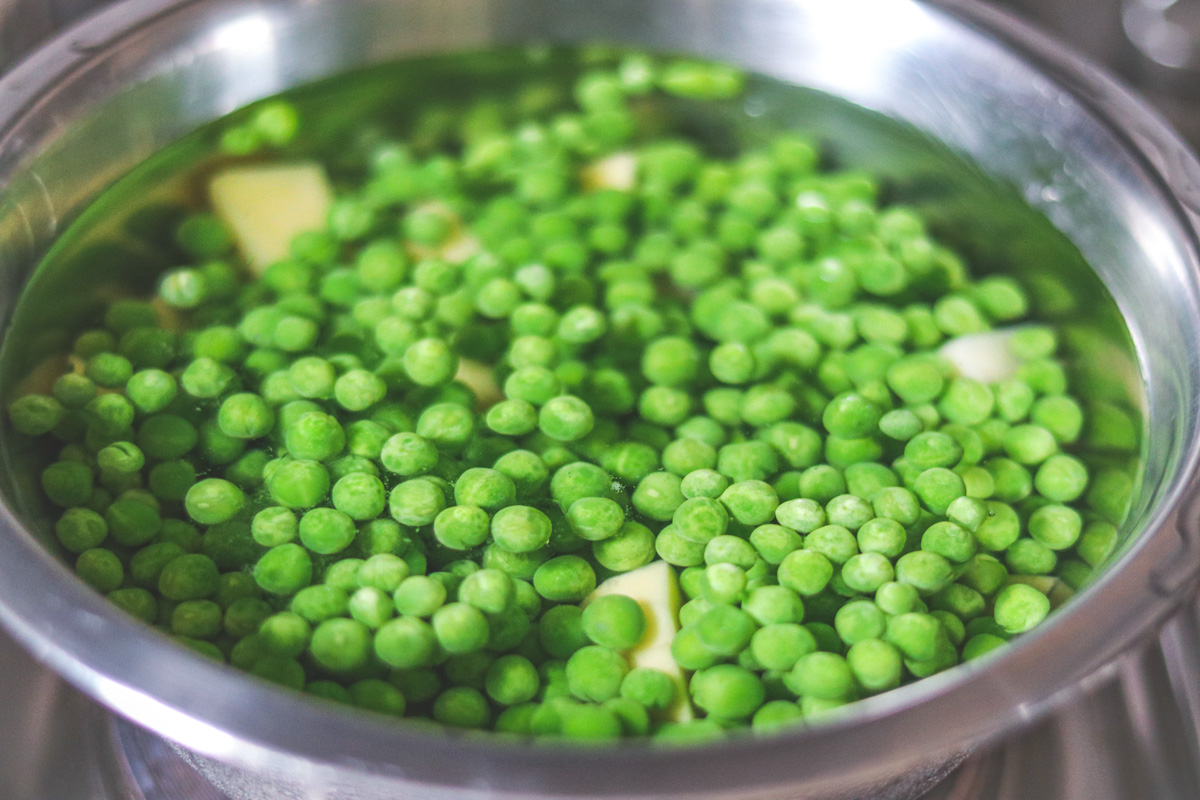Wash and parboil peas