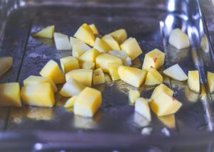 Cooked potatoes in baking tray