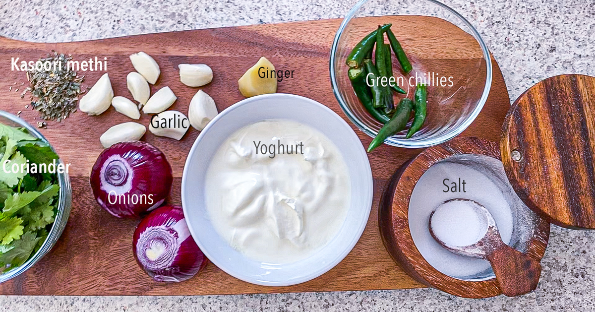 Onions ,garlic ,coriander, yoghurt, green chillies , salt in bowls